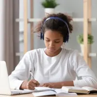 young woman studying and listening to music
