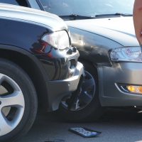 Traffic accident. Wrecked car. Car crash accident on street, damaged automobiles after collision in city